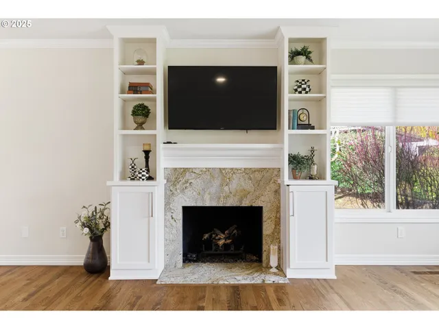 a living room with a fireplace and a flat screen tv