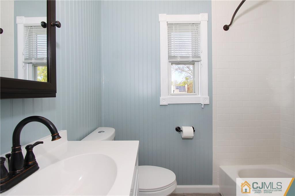 14 Wilshire Road Edison, NJ 08817 - Photo 13 of 22 a bathroom with a toilet sink and mirror