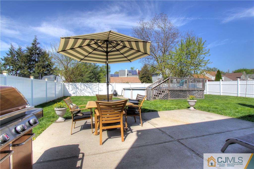 14 Wilshire Road Edison, NJ 08817 - Photo 19 of 22 a patio with a table and chairs
