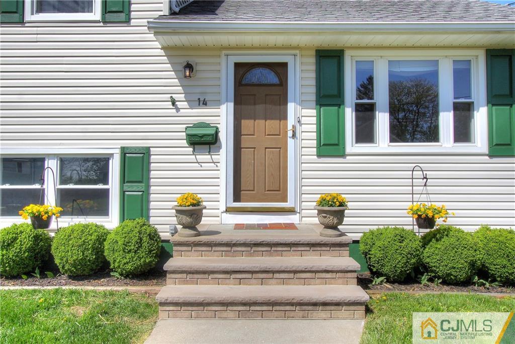14 Wilshire Road Edison, NJ 08817 - Photo 3 of 22 a view of a house with potted plants and a large window