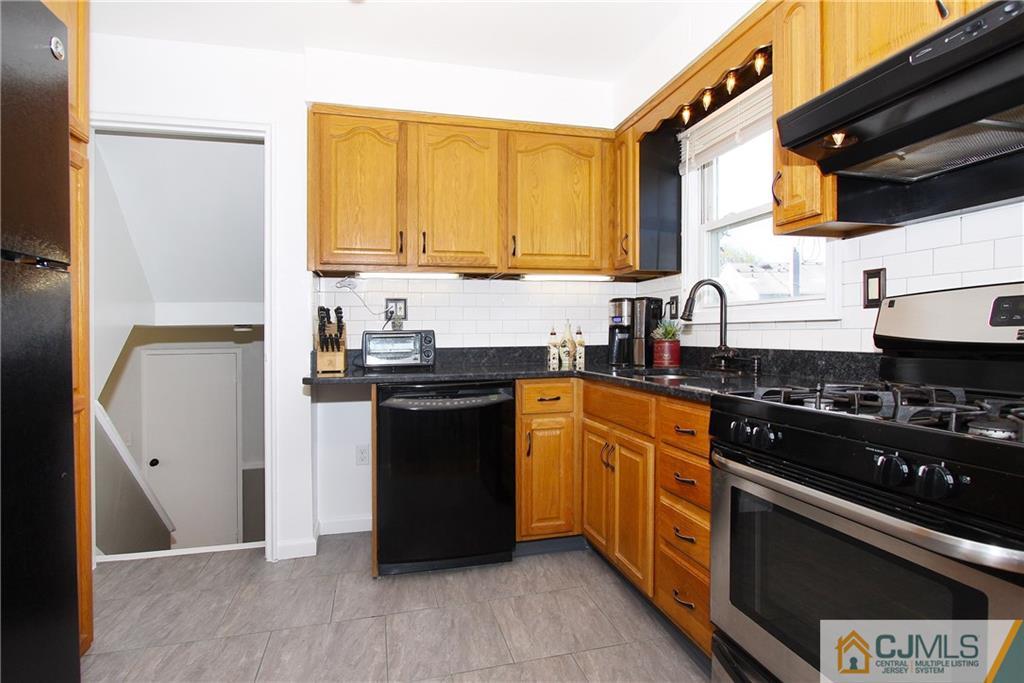 14 Wilshire Road Edison, NJ 08817 - Photo 7 of 22 a kitchen with stainless steel appliances granite countertop a stove a sink and a refrigerator