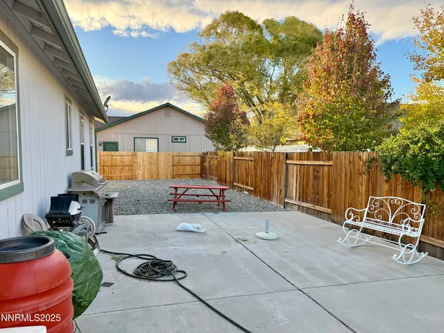 a view of backyard with a patio and outdoor seating