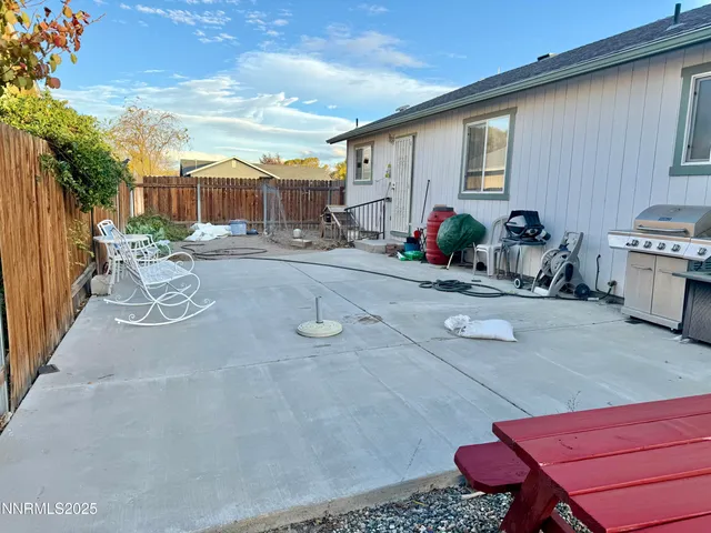 a view of a chairs and tables in the back yard of the house