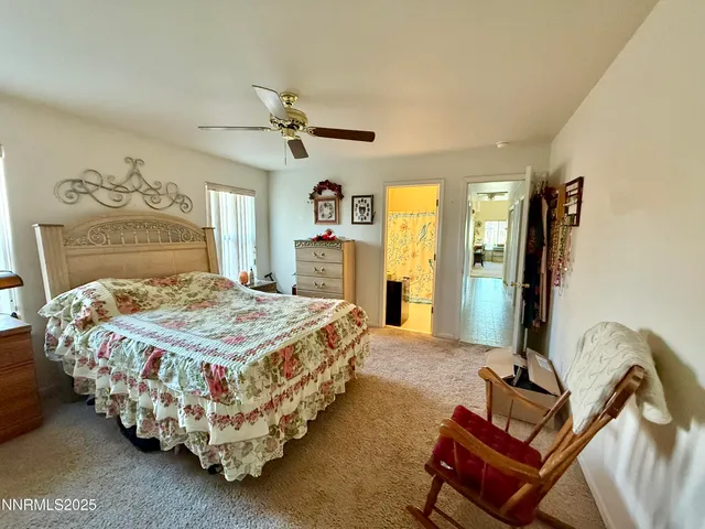 a bedroom with a bed chair and dresser