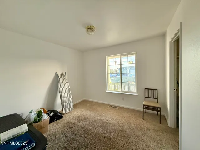 a view of a room with window and a ceiling fan