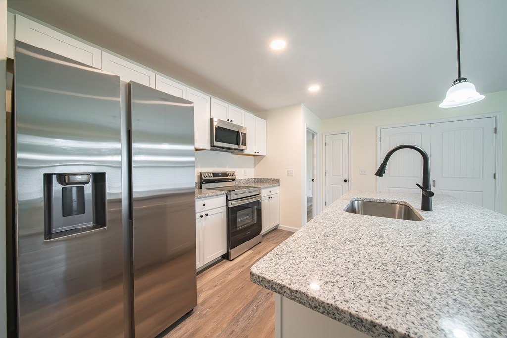 4396 Forrest Road Columbus, GA 31907 - Photo 13 of 24 a kitchen with stainless steel appliances granite countertop a sink a stove and refrigerator