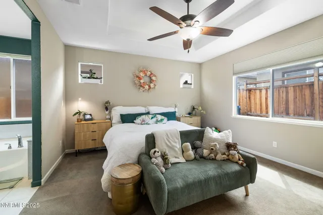 a spacious bedroom with a bed and a window