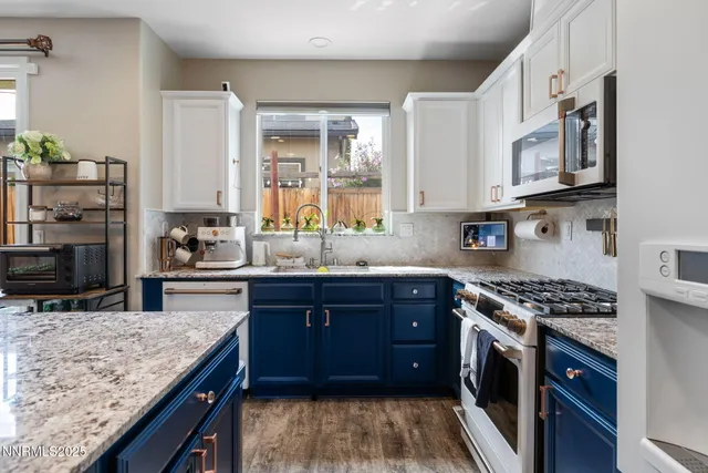 a kitchen with stainless steel appliances granite countertop a stove a sink dishwasher and a refrigerator