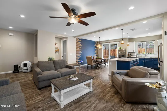 a living room with furniture and a view of kitchen