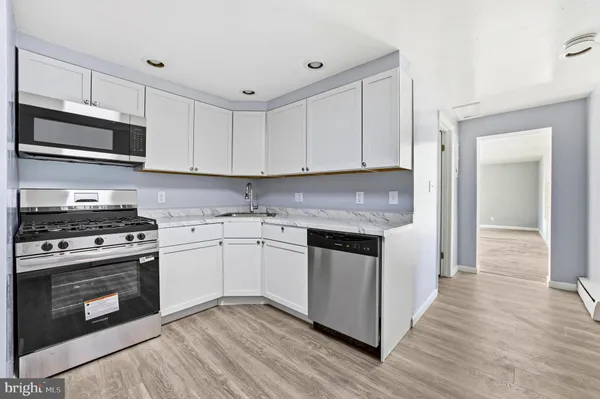 a kitchen with stainless steel appliances granite countertop a stove and a sink