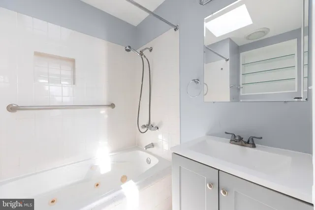 a bathroom with a bathtub and a shower