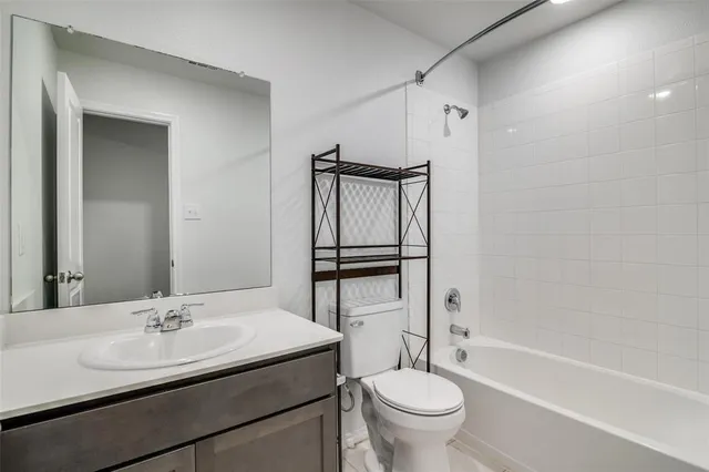 a bathroom with a sink toilet and a mirror