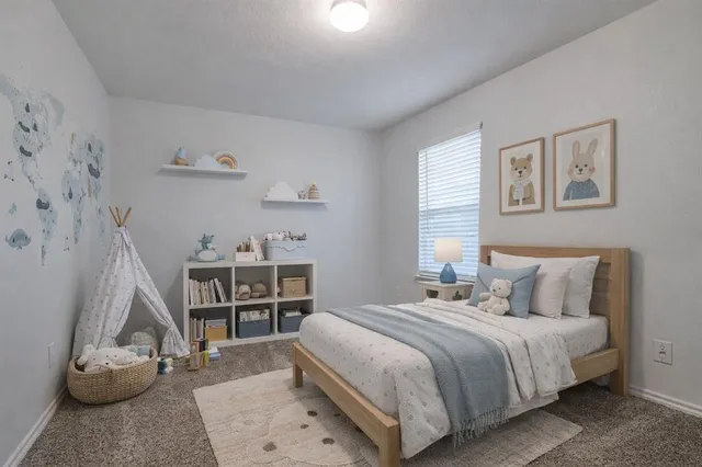 a bedroom with a bed and a wooden floor