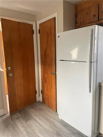 a white refrigerator freezer sitting in a kitchen