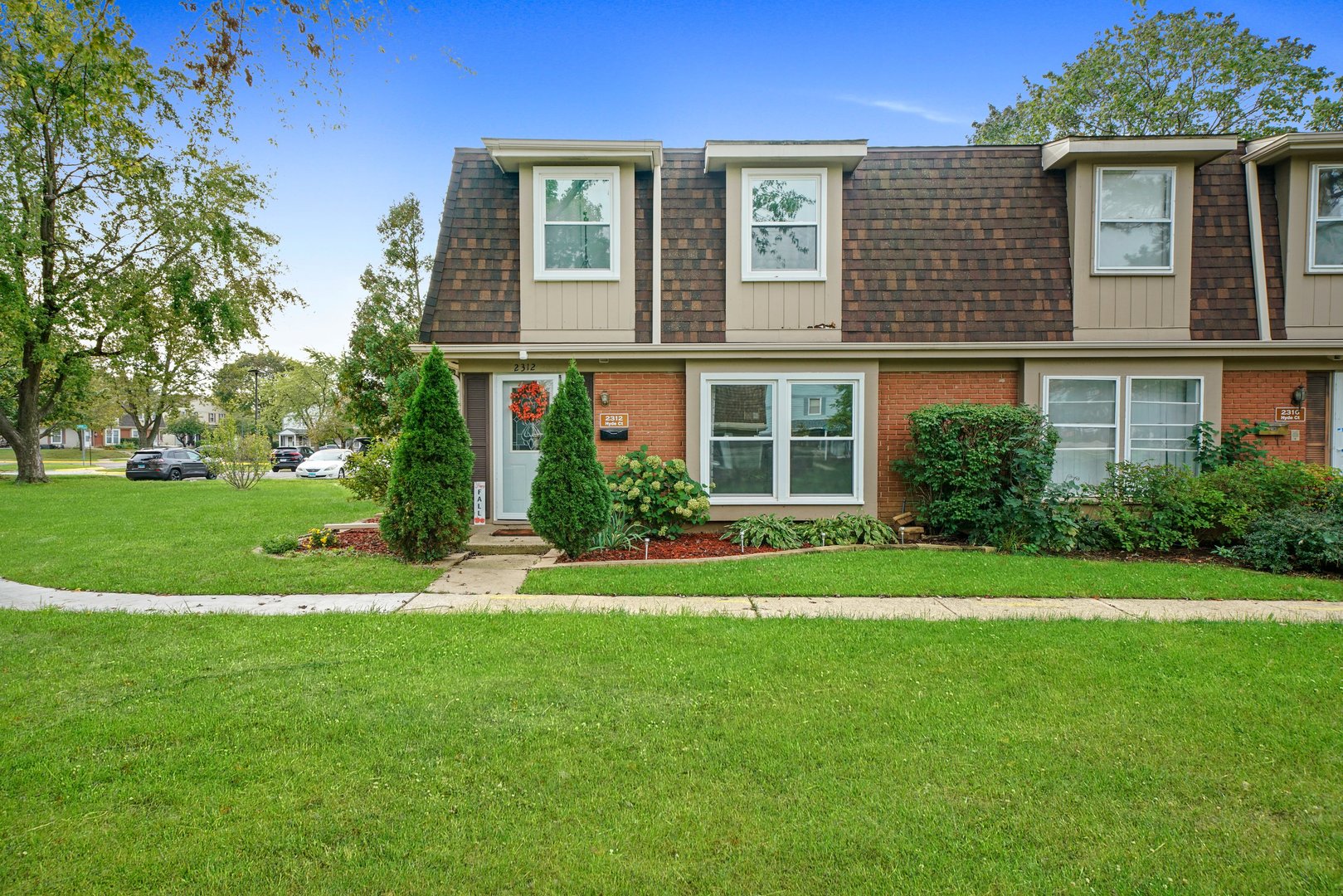 a front view of a house with a yard