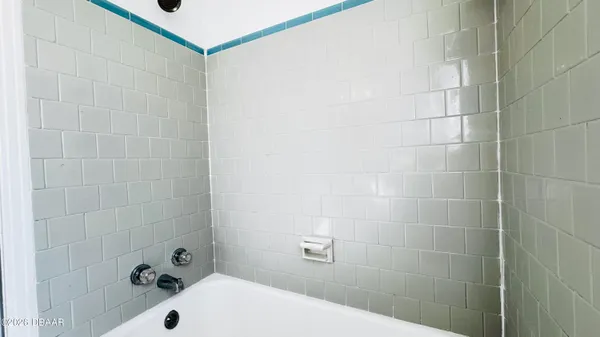 a bathroom with a bathtub and shower