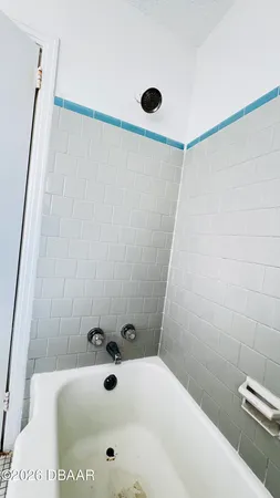 a bathroom with a tub and a shower