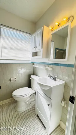 a bathroom with a sink toilet a mirror and vanity
