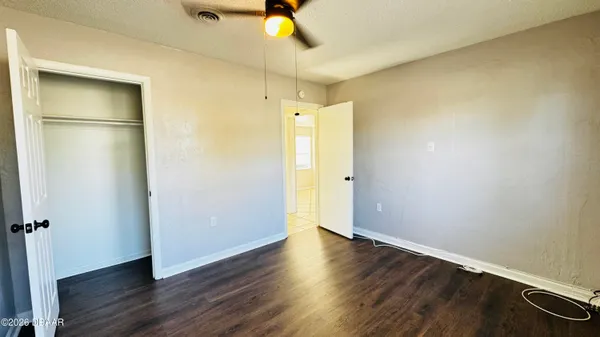 a view of a room with wooden floor