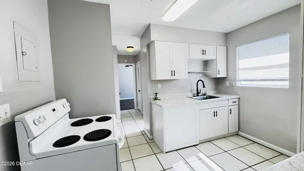 a kitchen with stainless steel appliances a stove a sink and a refrigerator