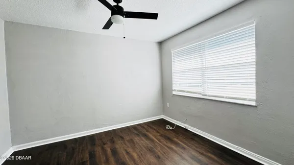 a view of a room with wooden floor and windows