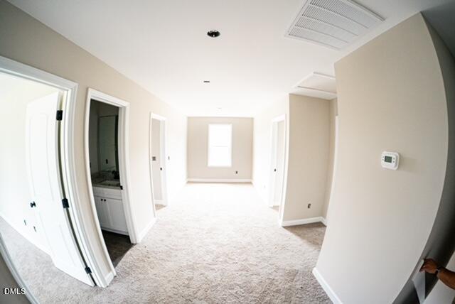 125 Wilson Street Erwin, NC 28339 - Photo 20 of 22 a view of a hallway with wooden floor and a living room