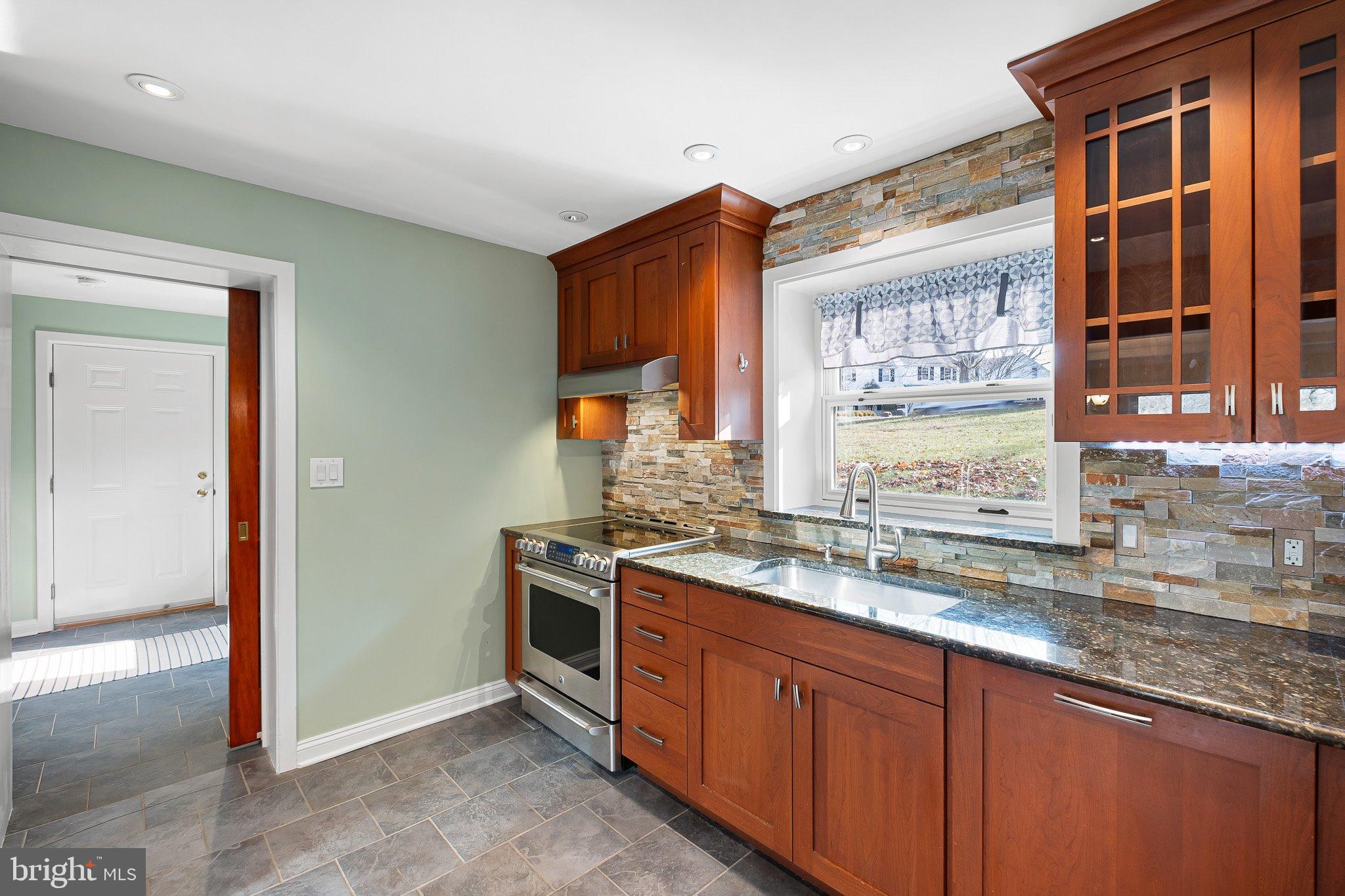 370 Marple Road Broomall, PA 19008 - Photo 19 of 46 a kitchen with stainless steel appliances granite countertop wooden cabinets a sink and a window