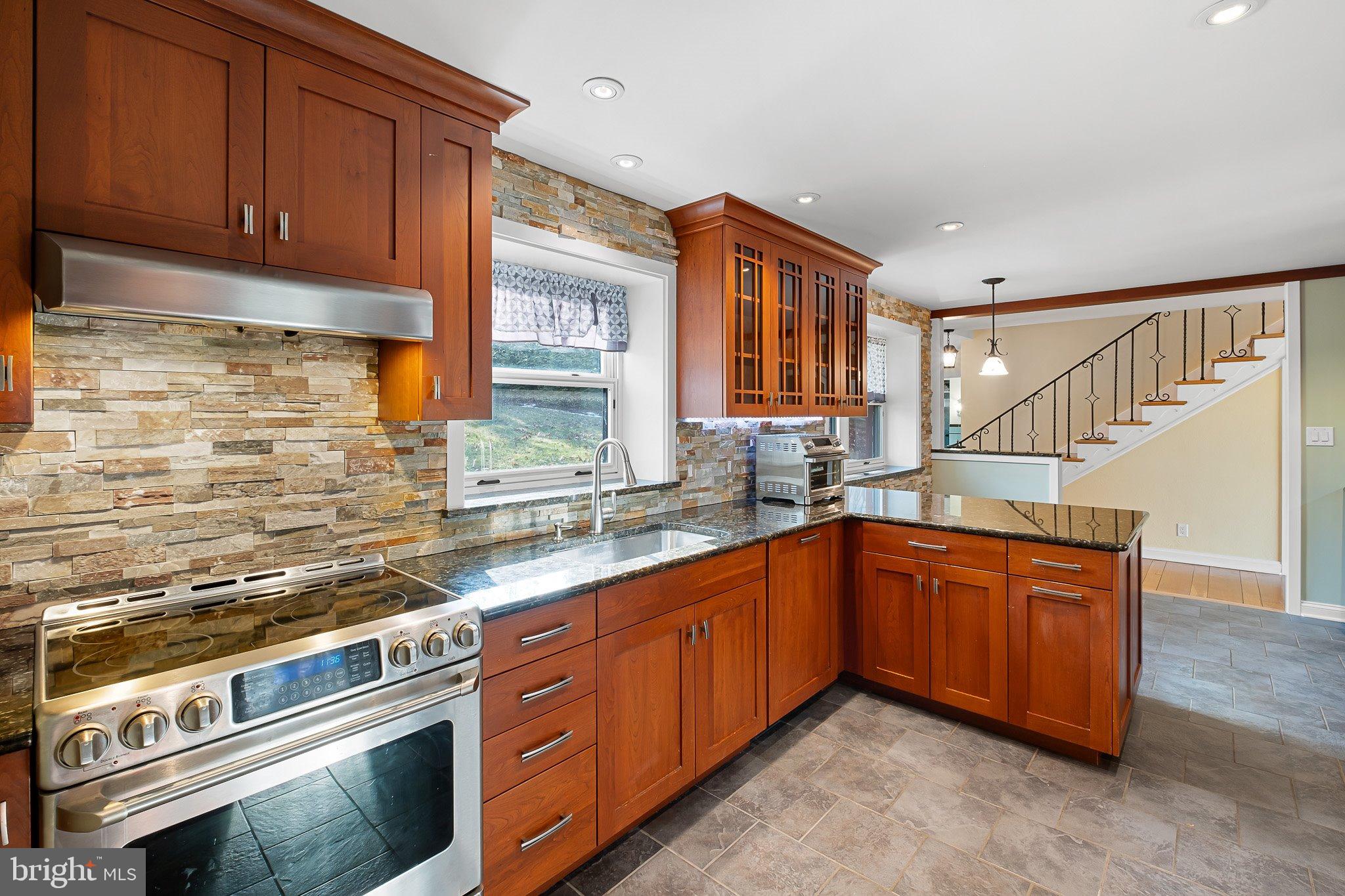 370 Marple Road Broomall, PA 19008 - Photo 21 of 46 a kitchen with stainless steel appliances granite countertop a sink and cabinets