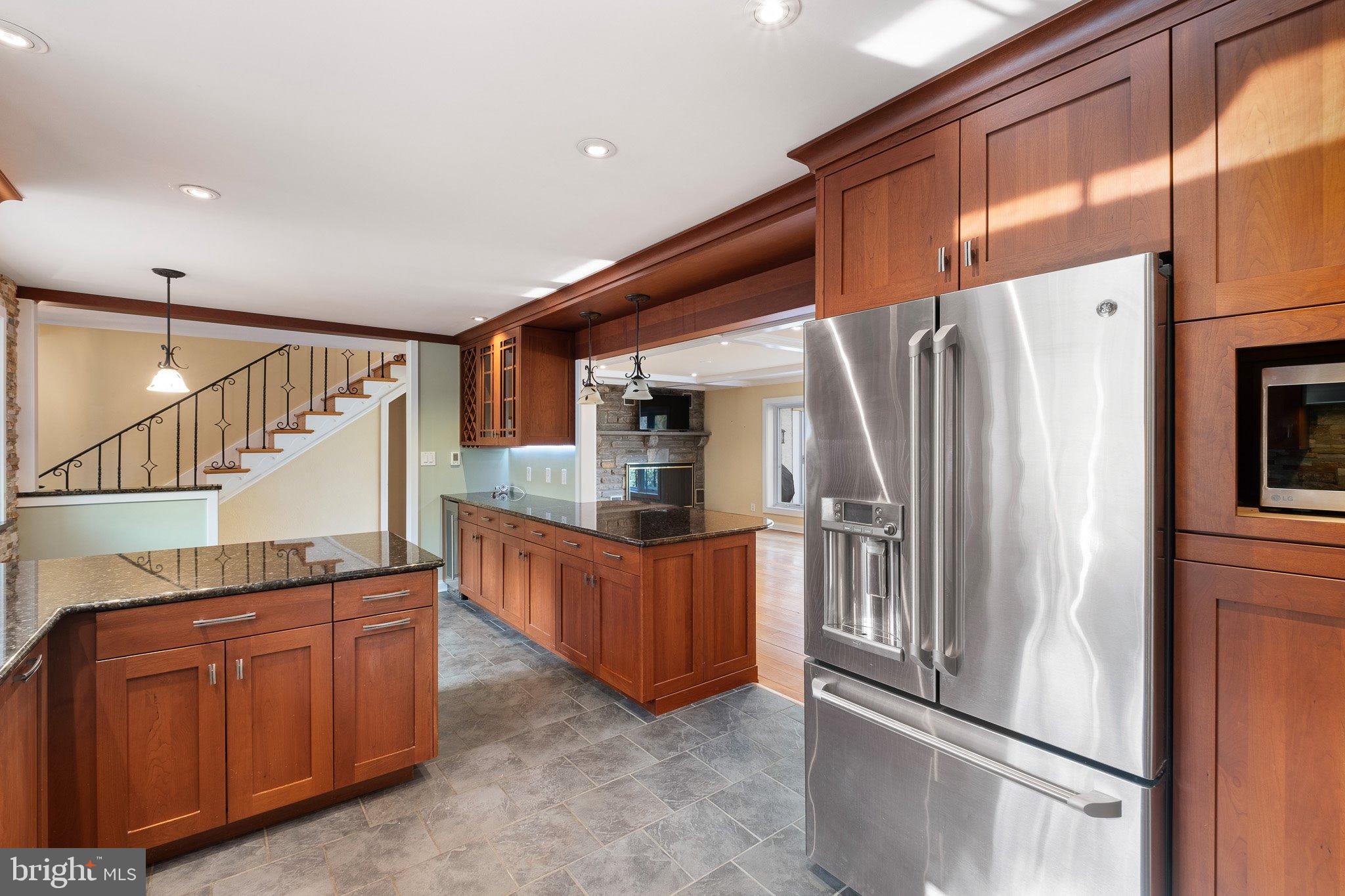 370 Marple Road Broomall, PA 19008 - Photo 22 of 46 a kitchen with granite countertop a refrigerator and a stove top oven