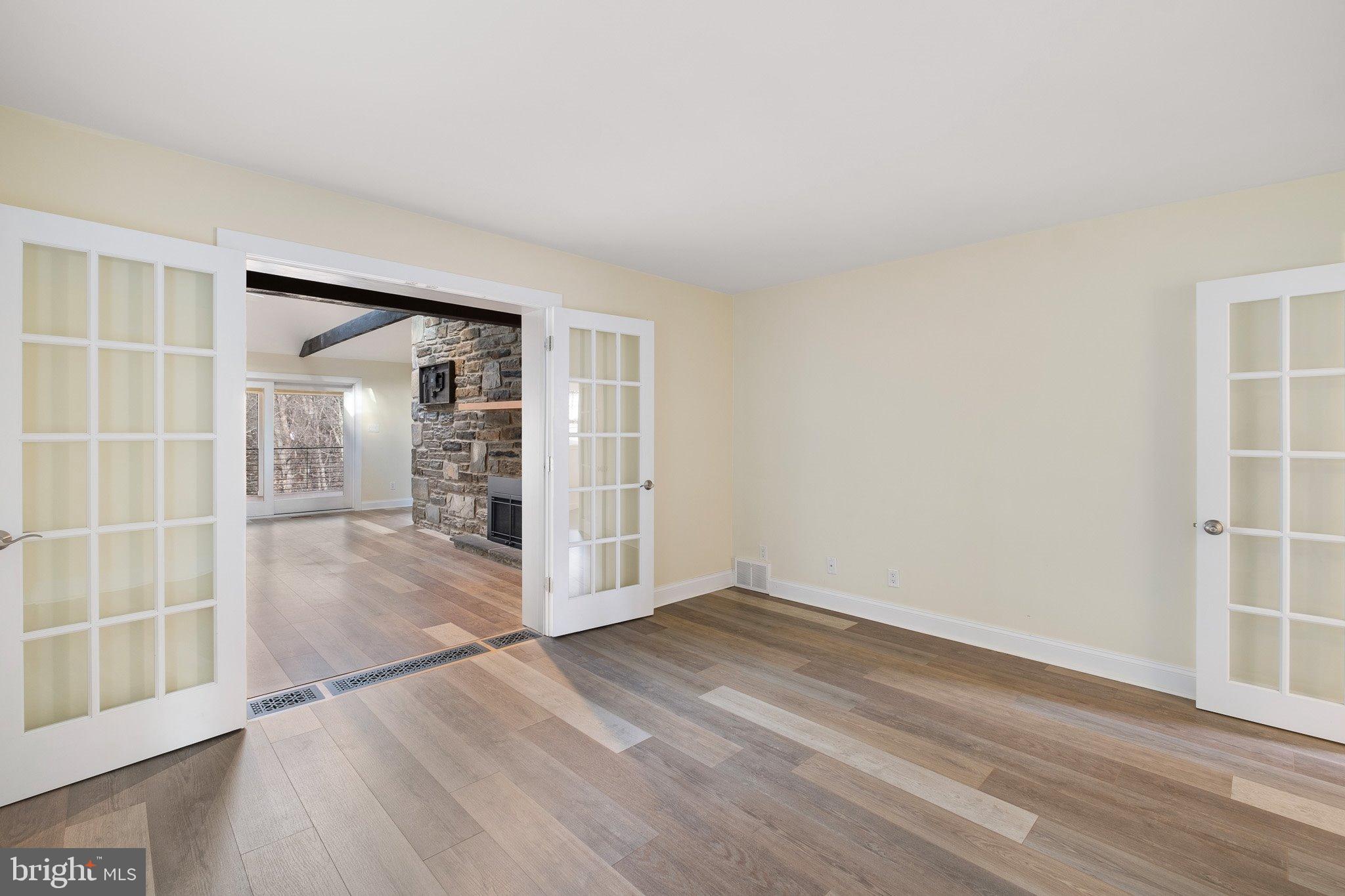 370 Marple Road Broomall, PA 19008 - Photo 29 of 46 an empty room with wooden floor and windows
