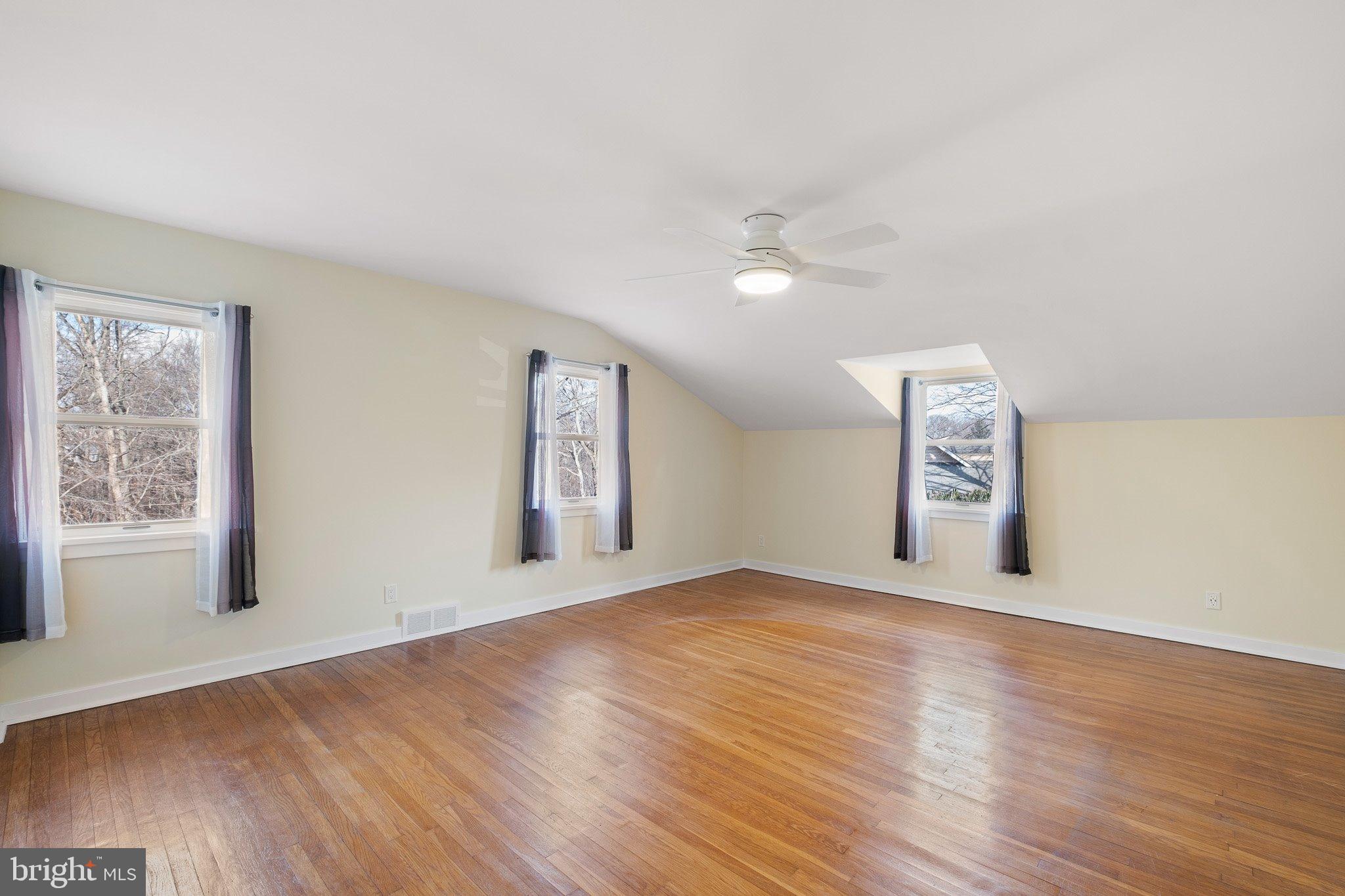 370 Marple Road Broomall, PA 19008 - Photo 42 of 46 an empty room with wooden floor and windows