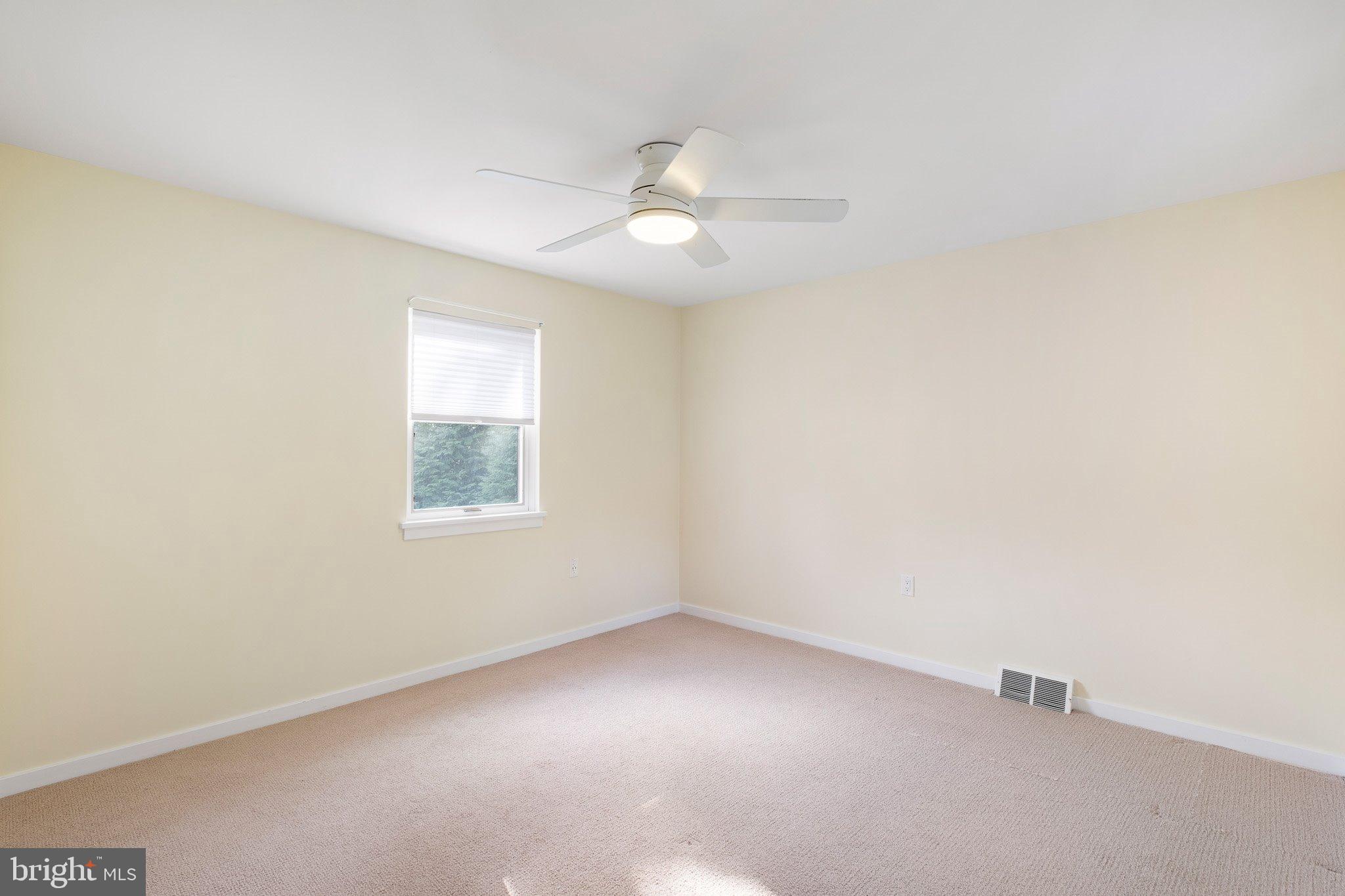 370 Marple Road Broomall, PA 19008 - Photo 45 of 46 an empty room with a window and ceiling fan