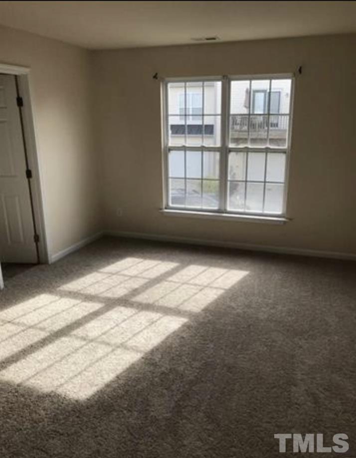 9705 Layla Avenue Raleigh, NC 27617 - Photo 3 of 5 a view of an empty room with a window