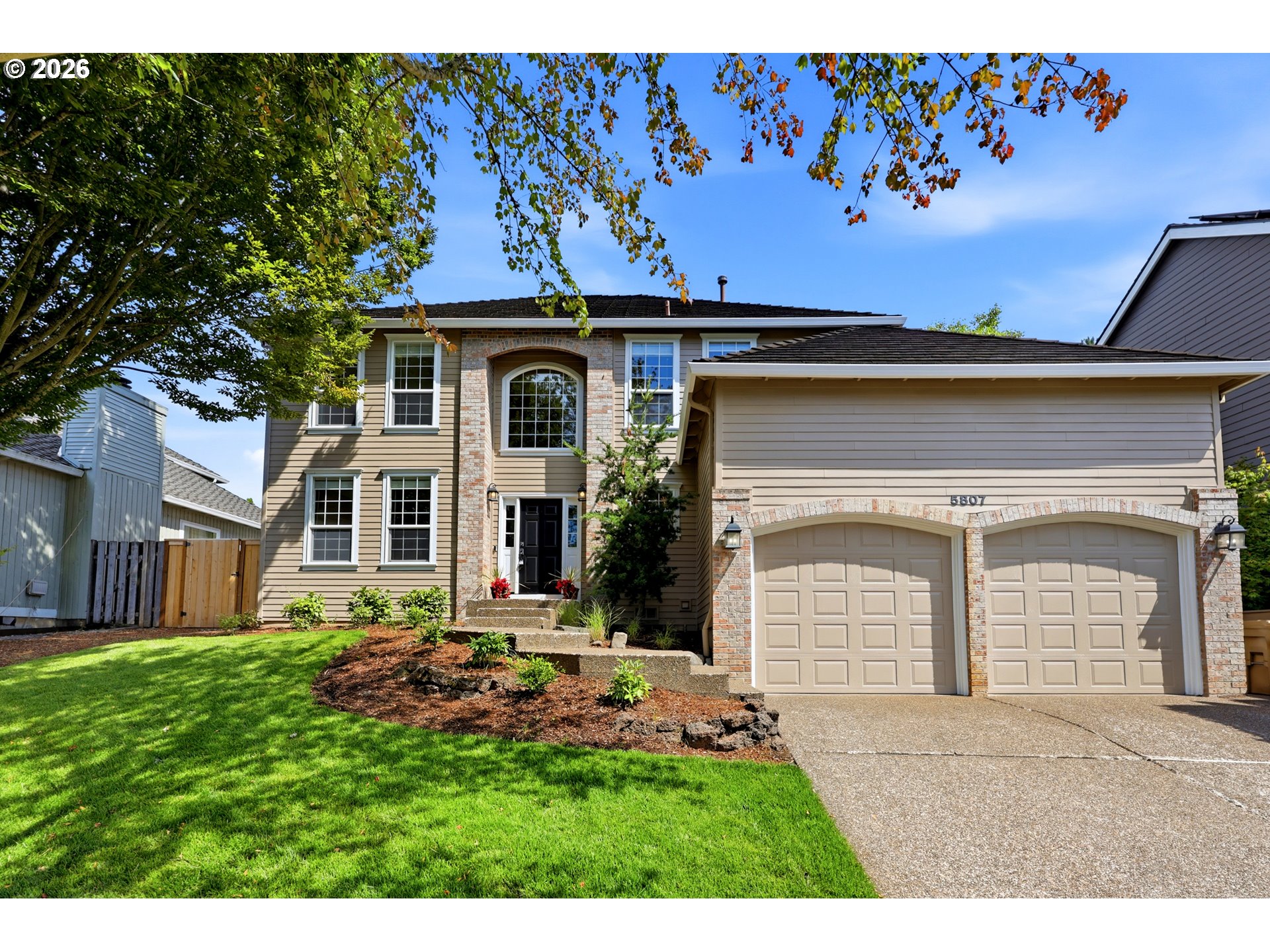 5807 Ridgetop Court Lake Oswego, OR 97035 - Photo 2 of 42 a front view of a house with a garden and yard