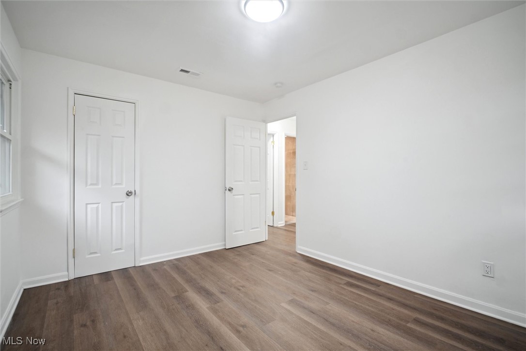 8796 West Ridgewood Drive Cleveland, OH 44130 - Photo 29 of 38 Unfurnished bedroom featuring wood-type flooring and a closet