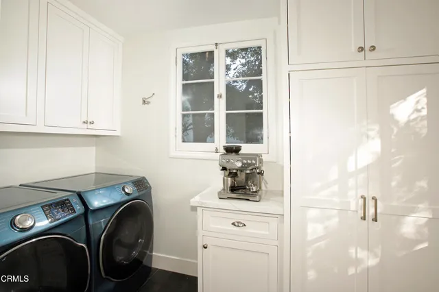 a view of a storage and utility room with washer and dryer