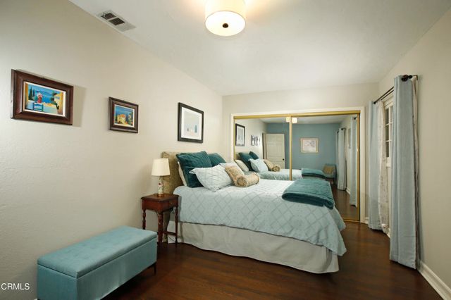 a bedroom with a bed and a couch