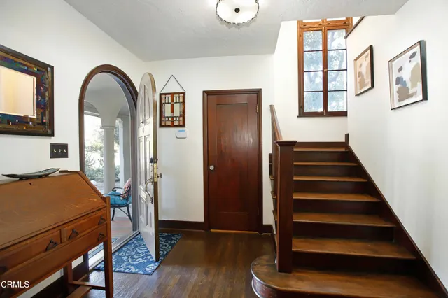 a view of an entryway with wooden floor and door