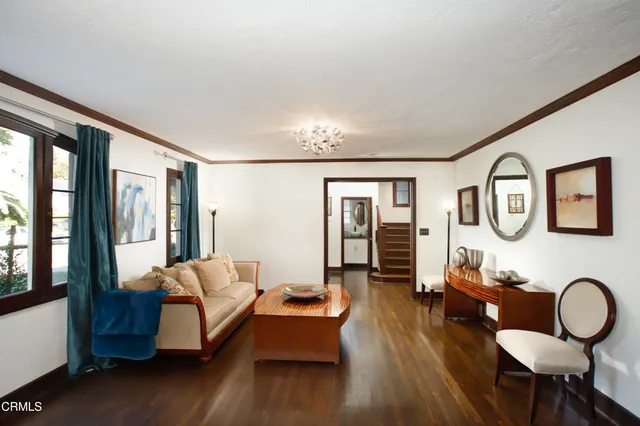 a living room with furniture and wooden floor
