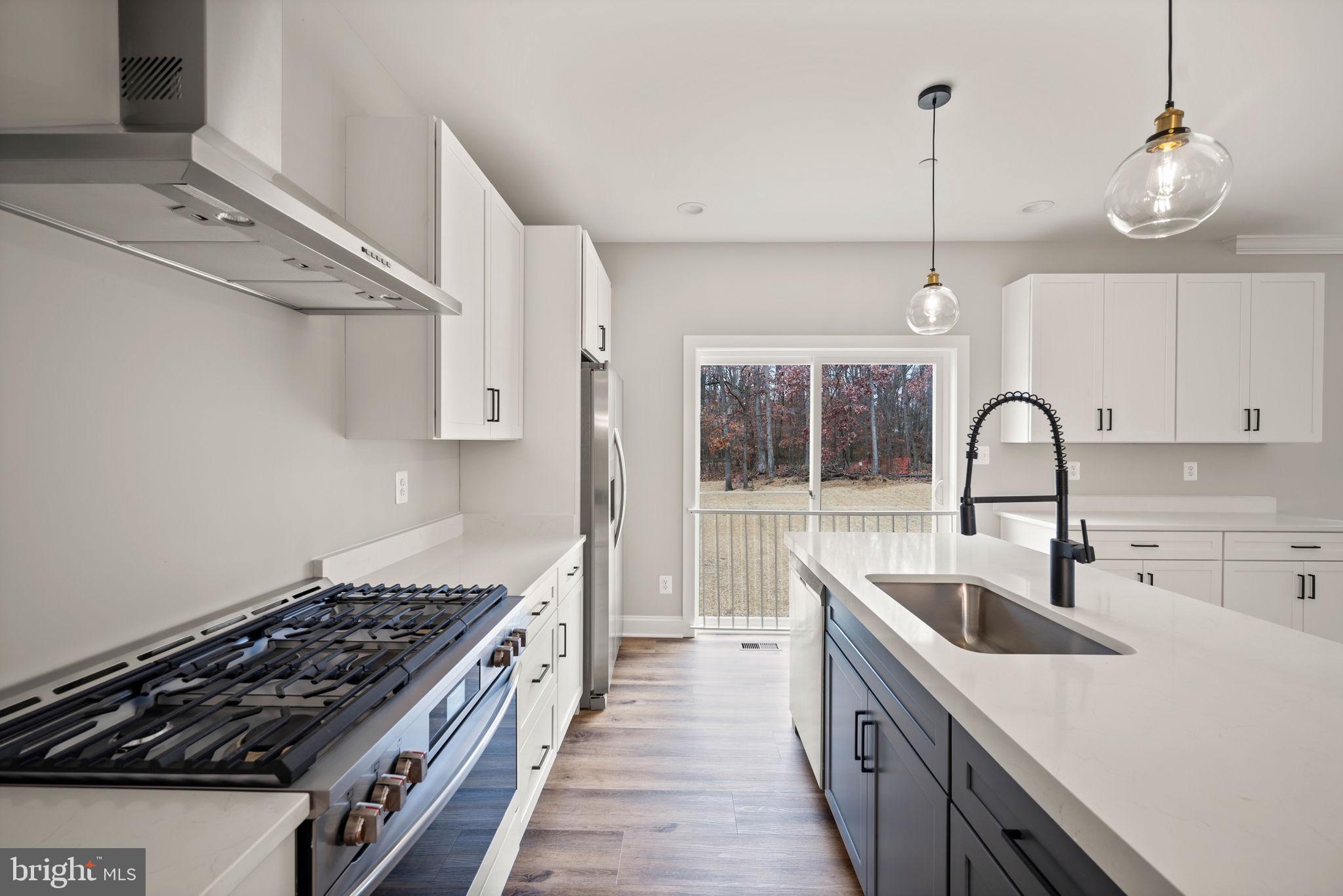 9436 Ridgely Avenue Baltimore, MD 21234 - Photo 11 of 44 a kitchen with stainless steel appliances granite countertop a sink stove and cabinets