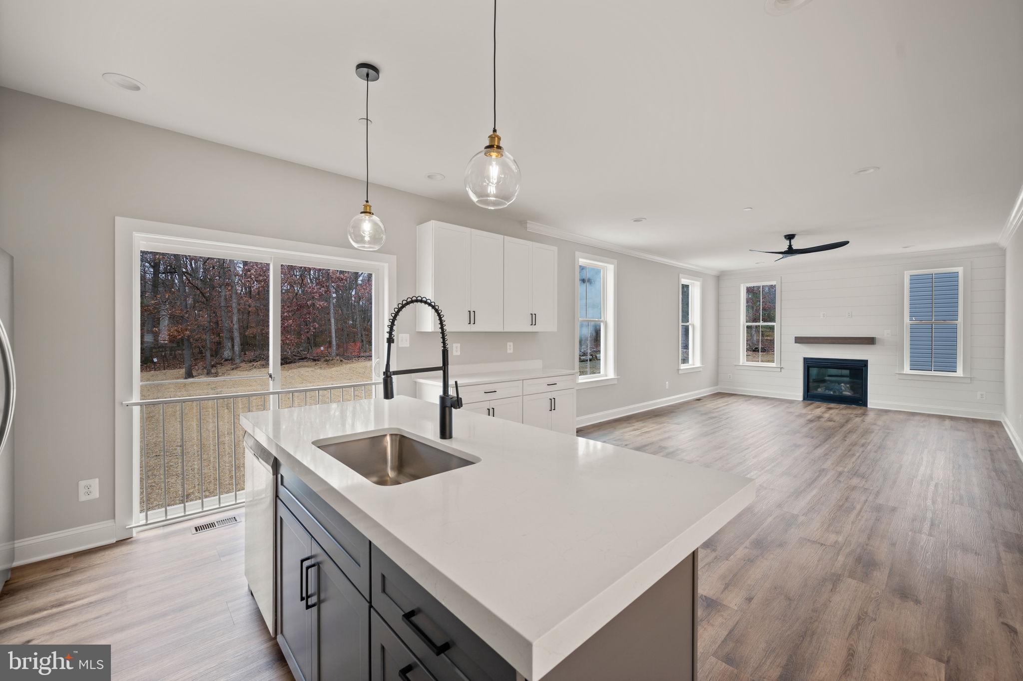 9436 Ridgely Avenue Baltimore, MD 21234 - Photo 12 of 44 a kitchen with kitchen island a sink and a stove with wooden floor