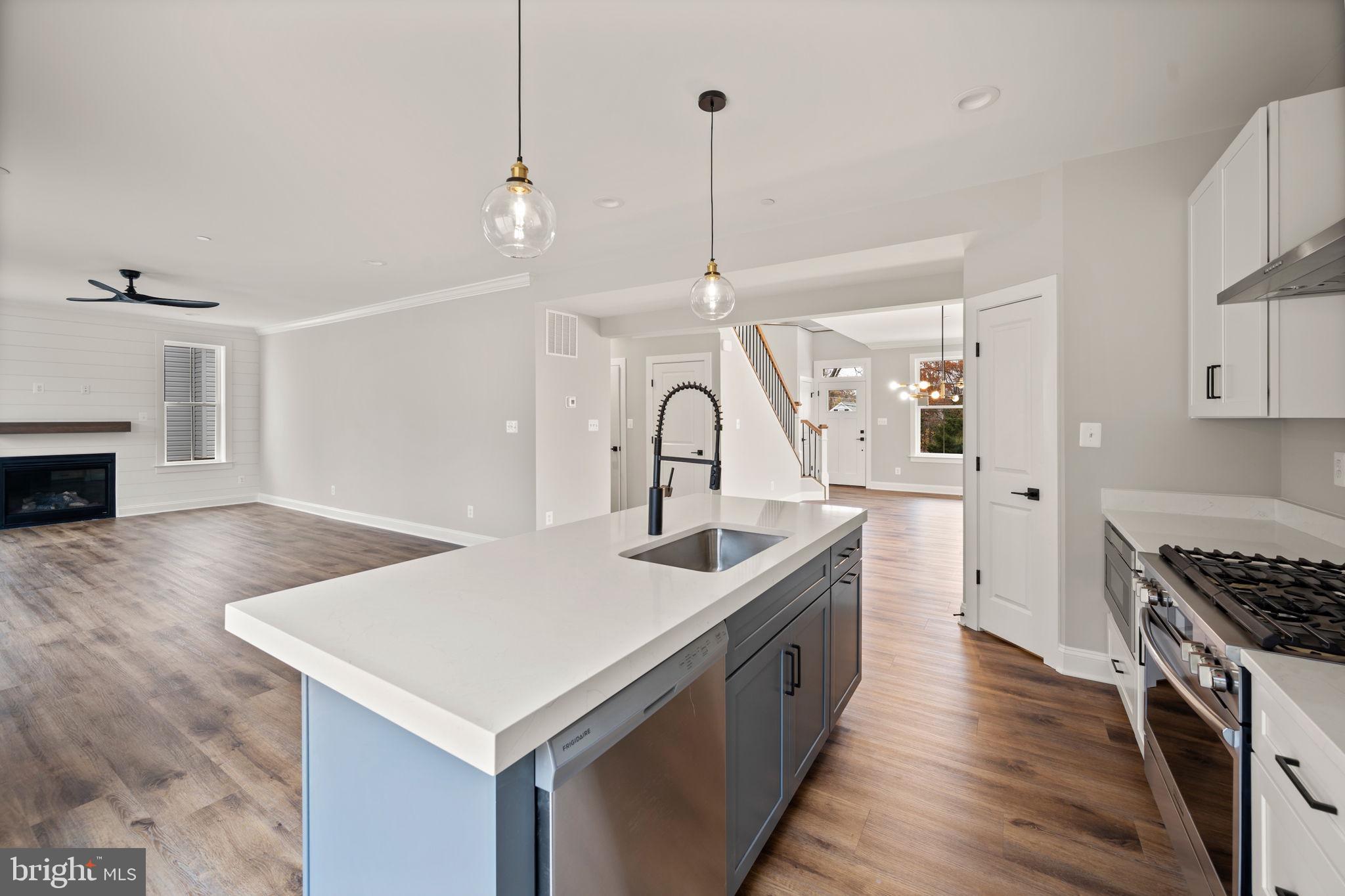 9436 Ridgely Avenue Baltimore, MD 21234 - Photo 13 of 44 a kitchen with sink stove and wooden floor