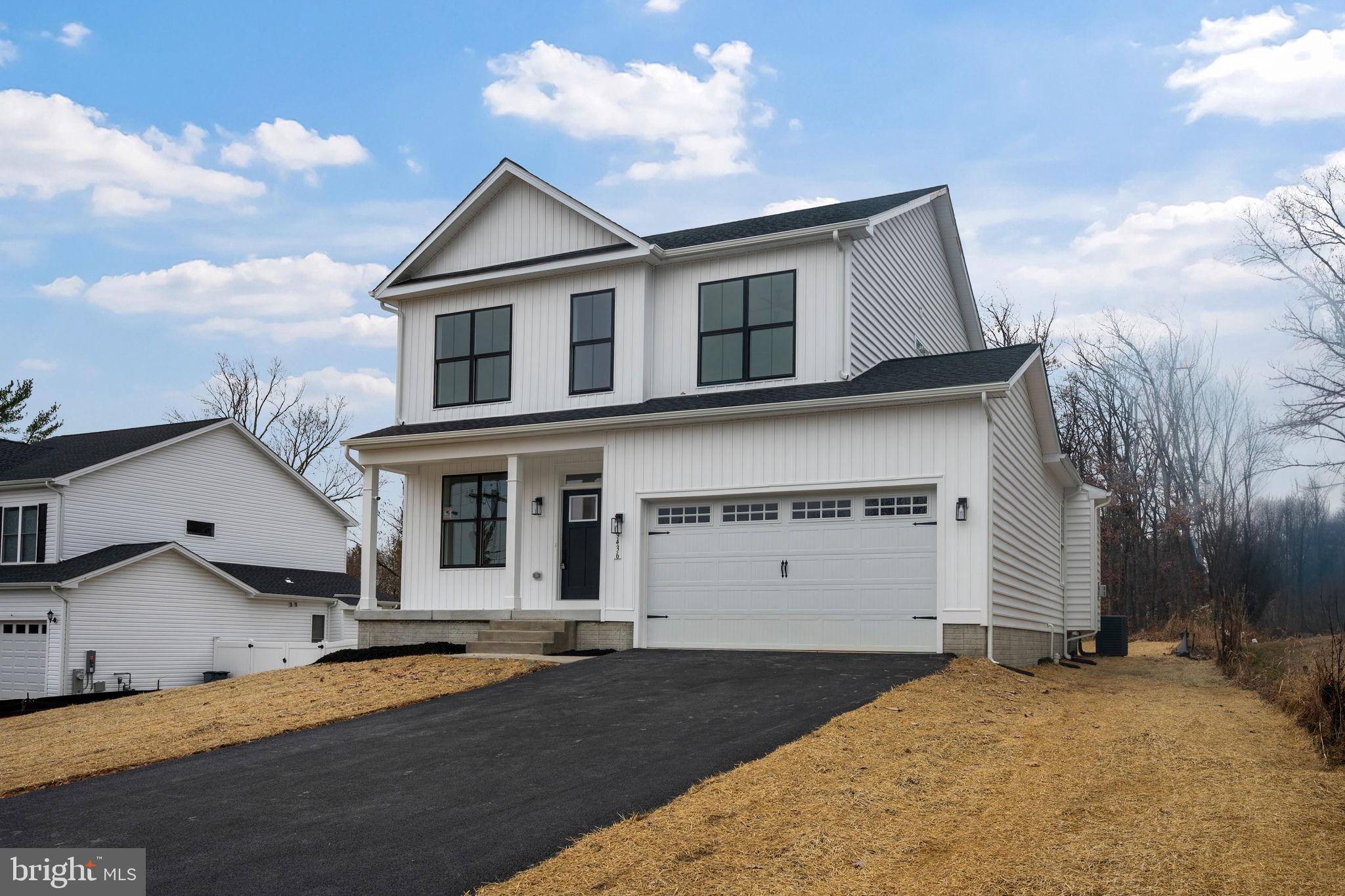9436 Ridgely Avenue Baltimore, MD 21234 - Photo 2 of 44 a view of a white house with a yard and garage