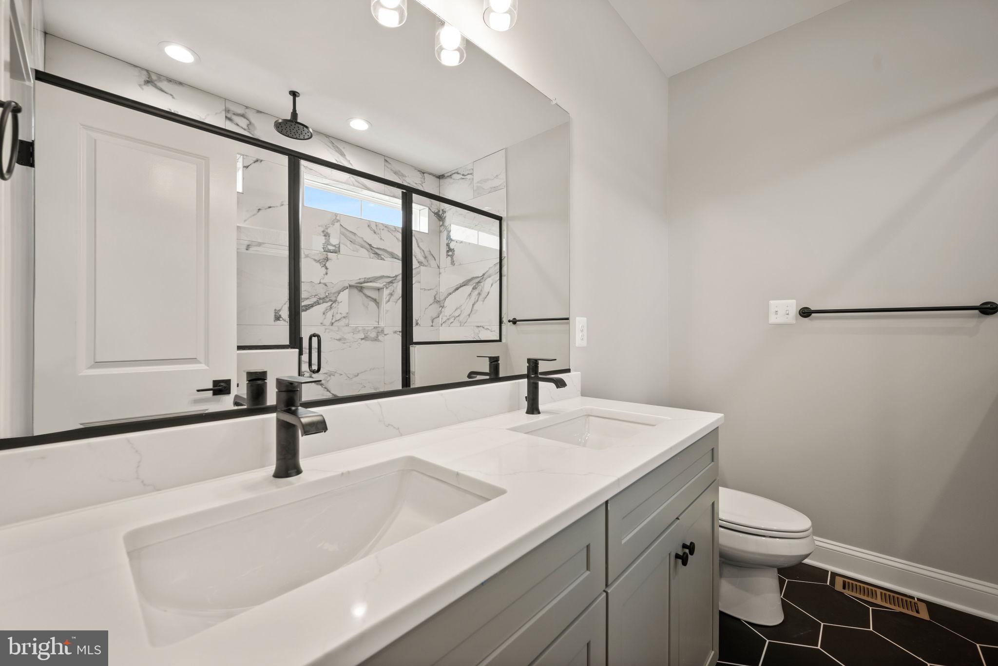 9436 Ridgely Avenue Baltimore, MD 21234 - Photo 22 of 44 a bathroom with a sink and a large mirror