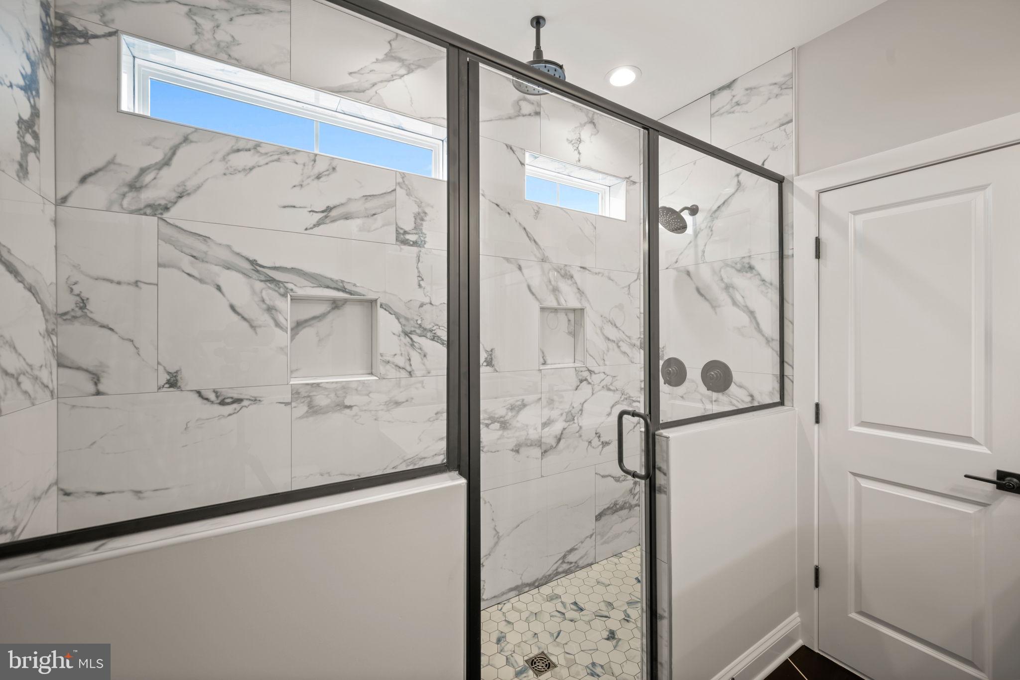 9436 Ridgely Avenue Baltimore, MD 21234 - Photo 24 of 44 a bathroom with a shower and mirror