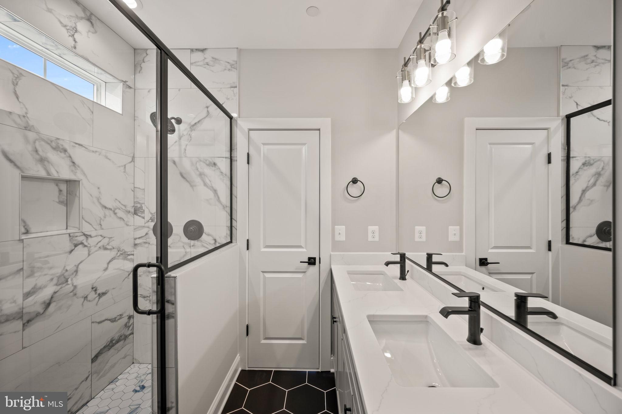 9436 Ridgely Avenue Baltimore, MD 21234 - Photo 25 of 44 a bathroom with a sink a mirror and shower