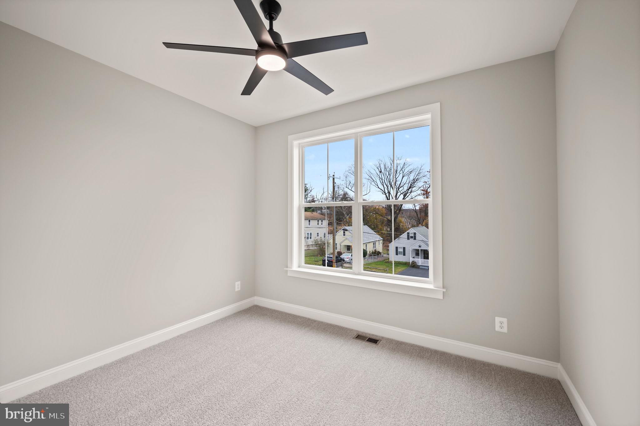 9436 Ridgely Avenue Baltimore, MD 21234 - Photo 28 of 44 an empty room with window and ceiling fan