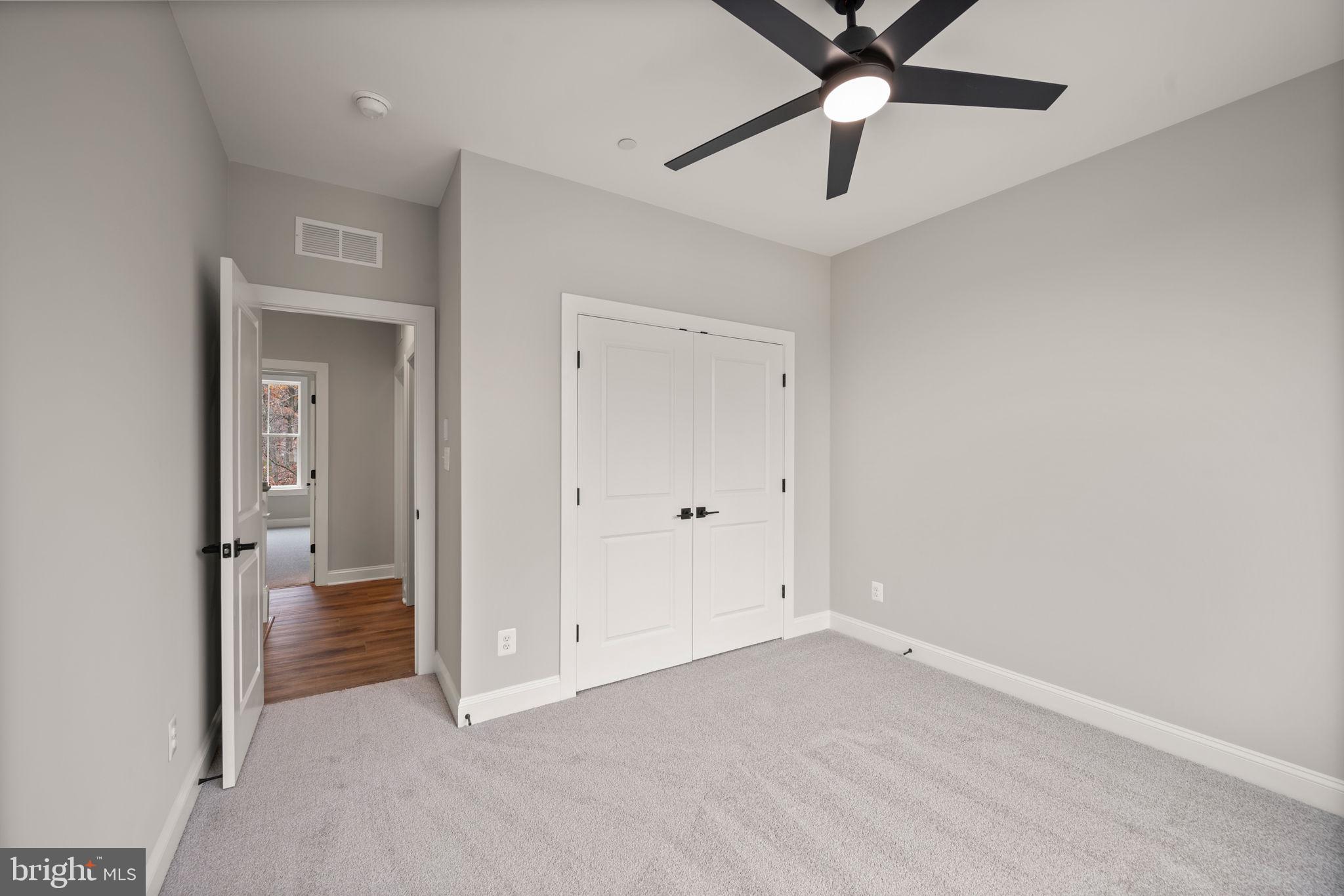 9436 Ridgely Avenue Baltimore, MD 21234 - Photo 29 of 44 a view of an empty room and a ceiling fan