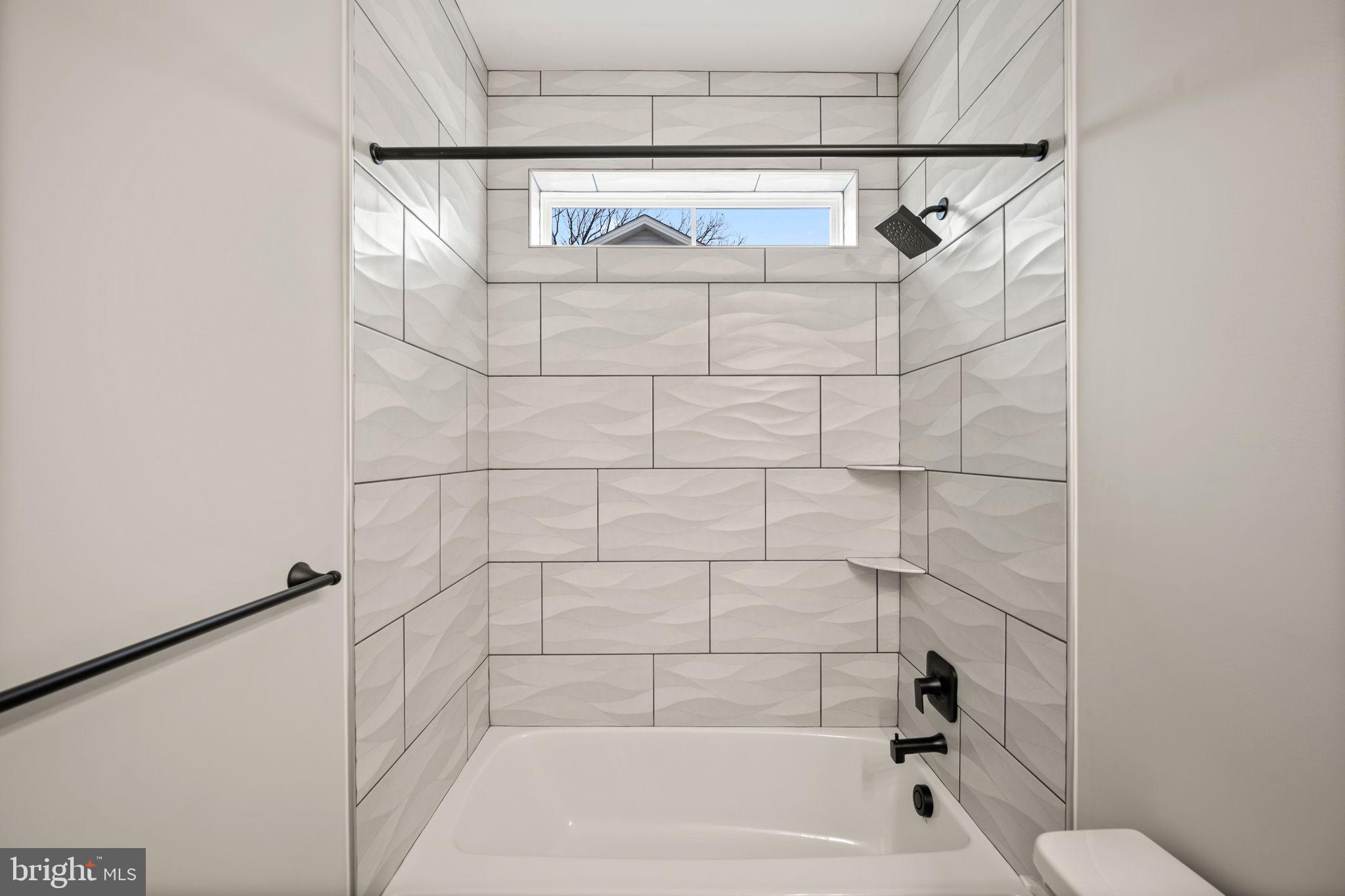 9436 Ridgely Avenue Baltimore, MD 21234 - Photo 31 of 44 a bathroom with a shower and a bathtub