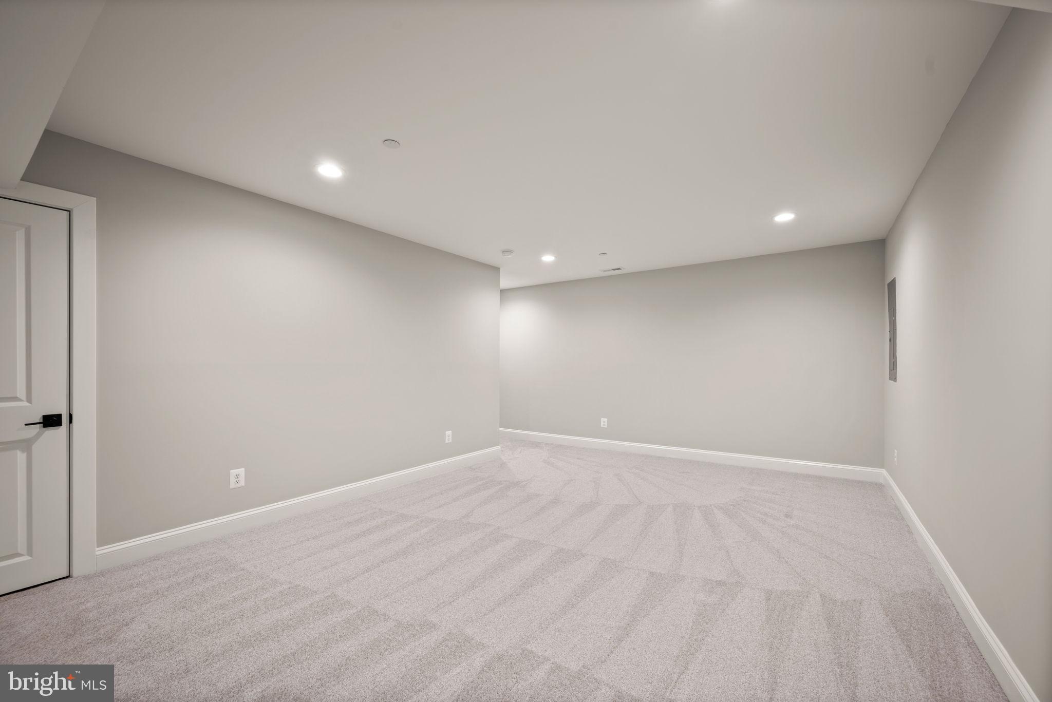 9436 Ridgely Avenue Baltimore, MD 21234 - Photo 33 of 44 an empty room with wooden floor and windows